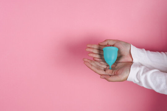Two Cupped Hands Hold Silicone Menstrual Cup To Promote Reusable Feminine Hygiene Care