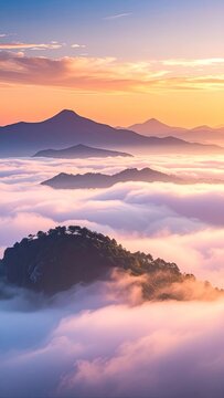 Serene mountain peaks emerge from a sea of clouds at sunrise.