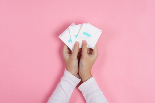 Close Up Of Female Hands Presenting Sanitary Pads To Display Feminine Hygiene Care