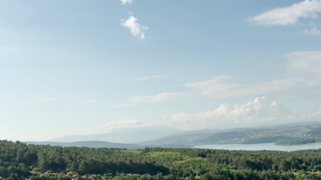 Mount Chatyr-Dag rests quietly on the horizon of Simferopol, Crimea. Vast green forests spread beneath a bright sky, bringing a lovely feeling of peaceful freedom.