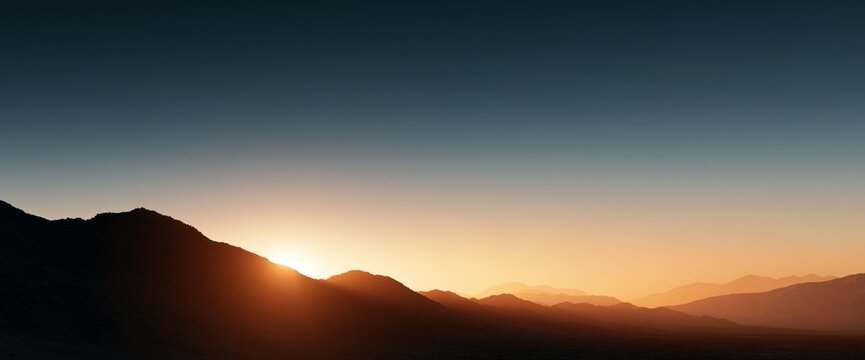 Sunset over layered mountain landscape