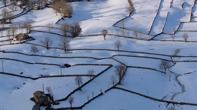 Aerial drone view of the winter landscape of hay meadows and traditional Pasiego cabins in the Burgos Mountains. Las Machorras, Pasiego Valleys, Merindades, Burgos, Castile and Le&oacute;n, Spain, Europe