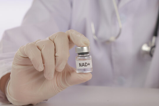 Functional medicine clinic professional holding NAD+ vial, healthcare concept showing modern treatment and wellness in clinical environment