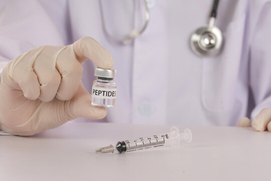 Functional medicine clinic concept with doctor holding peptide vial and syringe for modern healthcare treatment