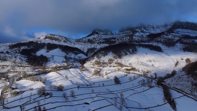 Aerial drone view of the winter landscape of hay meadows and traditional Pasiego cabins in the Burgos Mountains. Las Machorras, Pasiego Valleys, Merindades, Burgos, Castile and Le&oacute;n, Spain, Europe
