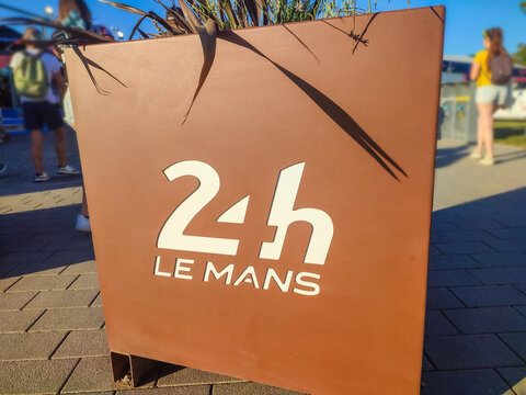 Le Mans, France - July 03, 2026: 24 Hours of Le Mans sign displayed prominently in outdoor setting with people and plants in background