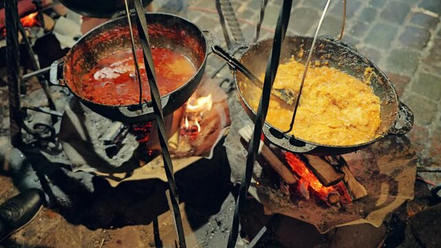 Authentic Outdoor Cooking with Cast Iron Pots During Festive Evening