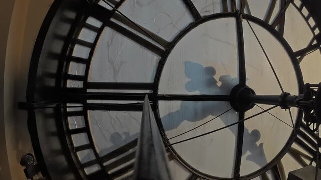 Interior timelapse of Daniels and Fisher Tower looking toward the frosted clock face as afternoon fades to sunset, clock hands move, and interior lights illuminate.