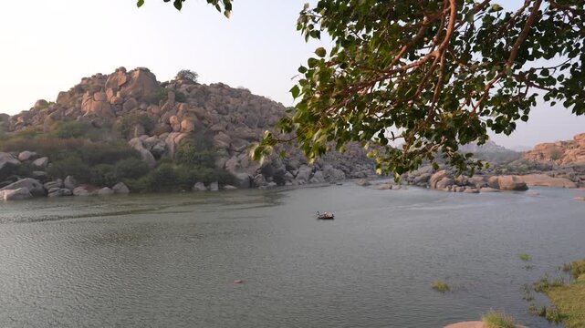 Scenic Wide Shot of Boating on the Tungabhadra River, Hampi, Karnataka, India