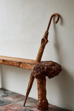 Live edge burl wood console table with wooden umbrella in Scandinavian entryway