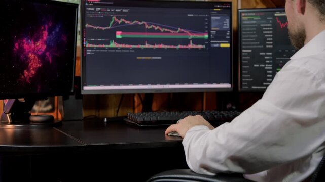 Trader monitors stock market trends on multiple screens during a trading session