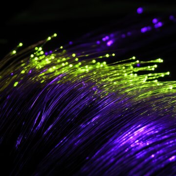 Vibrant fiber optic strands glowing with bright neon colors under dark background