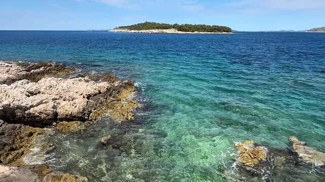 View of clear water and rocks near small island in Croatia on a sunny day