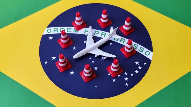 A mock up of airplane surrounded by no fly signs on a brazil flag as a concept for a flight ban or cancellation