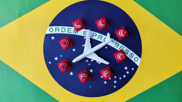 A mock up of airplane surrounded by no fly signs on a brazil flag as a concept for a flight ban or cancellation