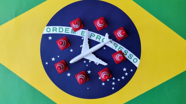 A mock up of airplane surrounded by no fly signs on a brazil flag as a concept for a flight ban or cancellation