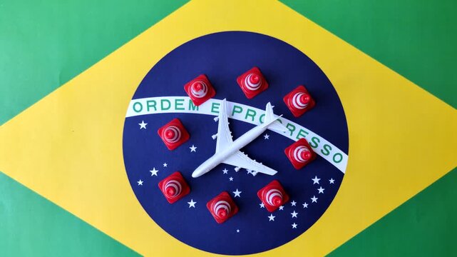 A mock up of airplane surrounded by no fly signs on a brazil flag as a concept for a flight ban or cancellation