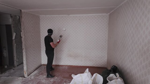 Documentary style scene captures early stage room demolition process