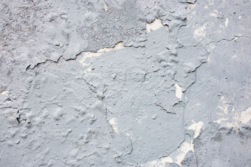 Weathered gray paint peeling on old metal cornice surface © Mariia