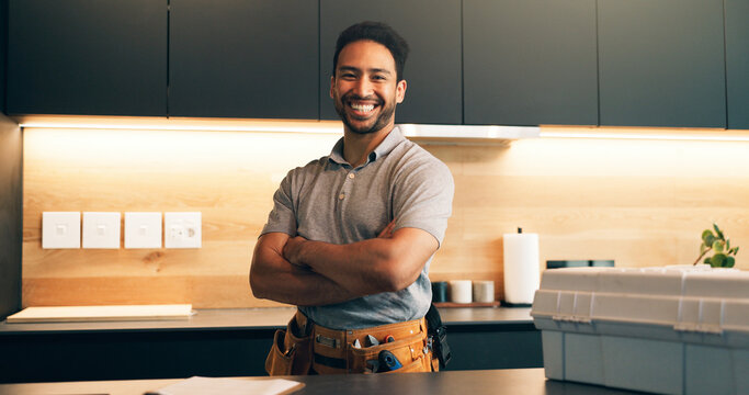 Plumber, tools and portrait of man in kitchen for plumbing service, maintenance and repair. Handyman, home and person with utility belt, pride and crossed arms for project, renovation and fixing