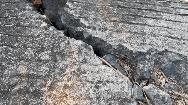 Severe structural damage on cracked concrete road