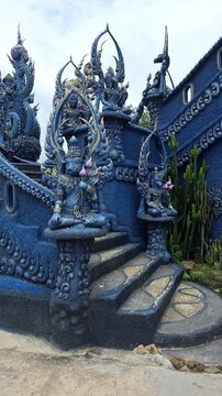 Slow motion footage of ornate staircase with Chinese zodiac animal deity statues at the Blue Temple