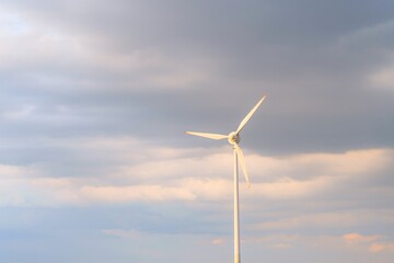 Fototapeta premium Electric power turbine with cloudy background
