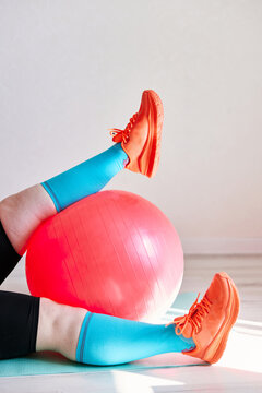 Person exercising with fitness ball at home