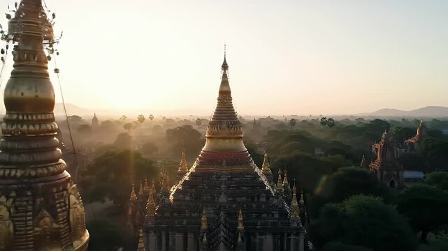 Golden stupas pierce the misty dawn over an ancient Burmese landscape.