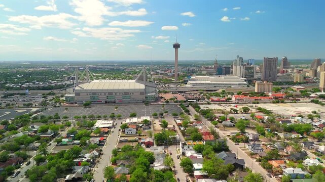 The drone pulls back from the Tower of the Americas gradually revealing the surrounding cityscape.