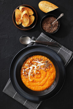 spiced sweet potato soup in a black bowl