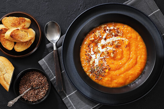 spiced sweet potato soup in a black bowl