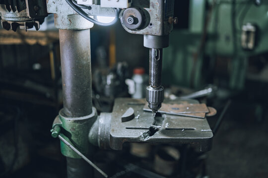 Close Up of Industrial Drill Press Machine in Small Community Metalworking Workshop