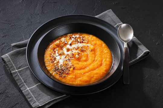 spiced sweet potato soup in a black bowl