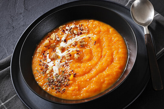 spiced sweet potato soup in a black bowl
