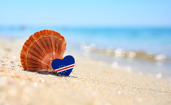 Sandy beach in Cape Verde. Flag of Cape Verde in the shape of a heart and a large shell.