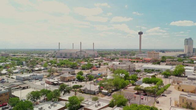 A wide aerial view captures the downtown skyline with the iconic tower standing tall above the city.
