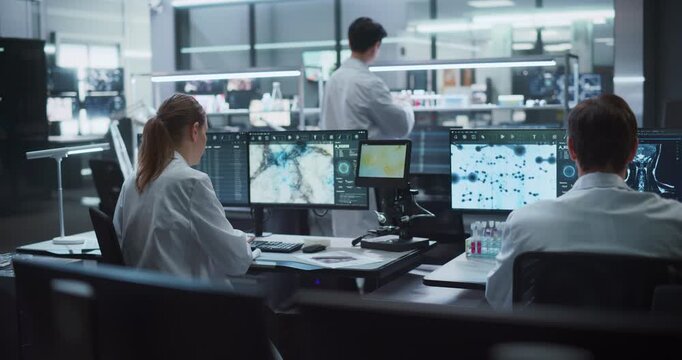 Team of Scientists Work on Drug Development and Disease Treatment in Modern Medical Research Facility, Analyzing Molecular Structures, Microscope Samples, and Brain Scans on Advanced Computer Monitors