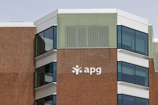 Amsterdam, Netherlands - 11 April 2026 - The brick and glass exterior facade of the APG pension fund asset management office building with its white corporate logo in Sloterdijk.