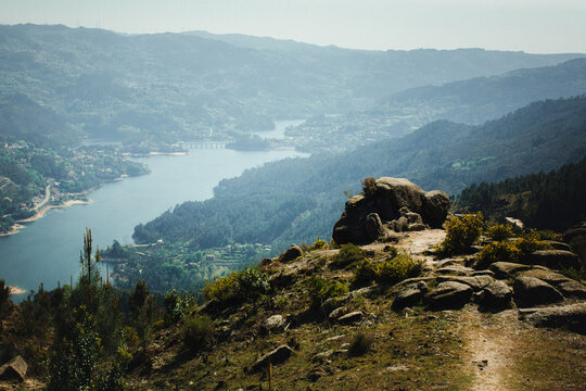 Panoramic mountain view over the Cavado River in Peneda Geres National Park Portugal with rocky foreground forested hills and peaceful natural scenery