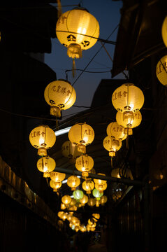 Chinese lanterns hanging above street at night in Bangkok