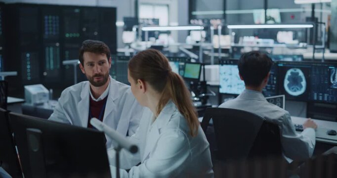 Diverse Team of Scientists Talk and Brainstorm in a Modern Medical Research Laboratory, Analyzing Brain Scans and Data on Computer Screens Using Ai Technology for Drug Development, Neurology Treatment