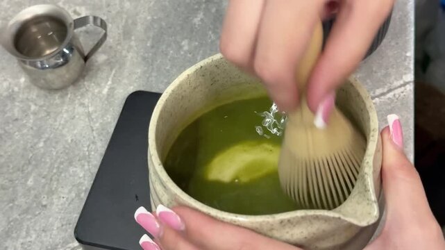 poor quality matcha is swamp green Iced matcha latte preparation in clear plastic cup showing pale green color uneven texture and diluted tea drink served with ice and black straw