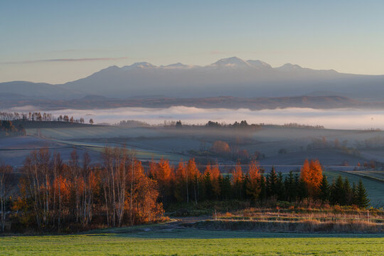 Sea of clouds over the rolling hills of Biei with the Tokachi Mountains in late autumn, Hokkaido, Japan