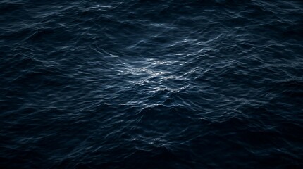 Obraz premium Dark water surface with subtle ripples and light reflections at night
