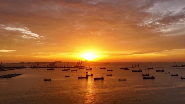  heavy oil tankers and LNG vessels anchored at a strategic maritime chokepoint during a golden sunset, emphasizing global energy crises and petroleum supply chain infrastructure.