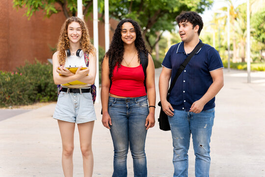 Diverse university students smiling, walking on campus, creating new friendships