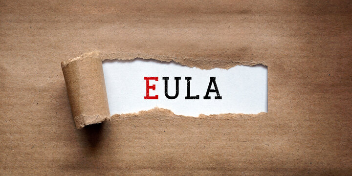 EULA, End User License Agreement - torn strip of brown kraft paper