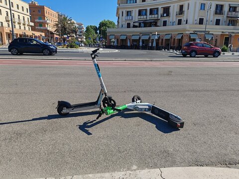 Ostia, Rome, Italy - May 8, 2026, scooters abandoned in the street in an uncivilized manner, on the seafront in front of the pier.