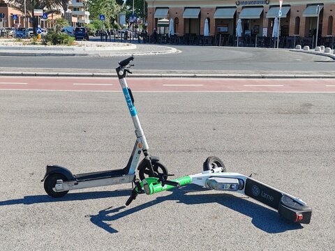 Ostia, Rome, Italy - May 8, 2026, scooters abandoned in the street in an uncivilized manner, on the seafront in front of the pier.